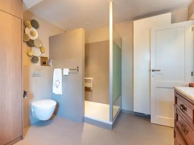 a bathroom with a toilet and a glass shower at Apartment in Kruibeke Wissekerke Castle in Kruibeke