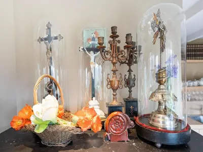 a table topped with a group of clocks and baskets at Apartment in Kruibeke Wissekerke Castle in Kruibeke
