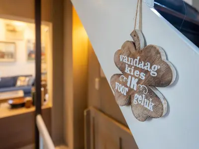 a wooden heart ornament hanging on a dresser at Apartment in Kruibeke Wissekerke Castle in Kruibeke