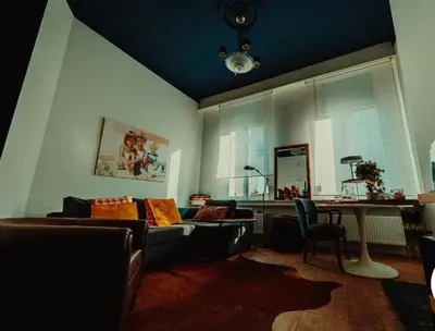 a living room with a couch and a table at Studio Dageraad in Antwerp