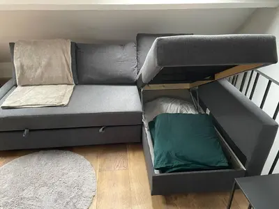 a gray couch with a bed in a room at Antwerpcityhome in Antwerp