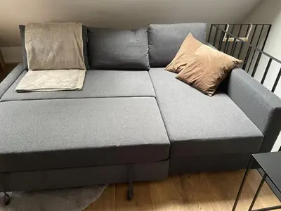 a couch with two pillows on it in a room at Antwerpcityhome in Antwerp