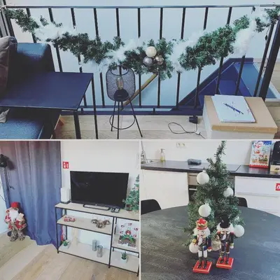 a living room with a christmas tree and a table at Antwerpcityhome in Antwerp