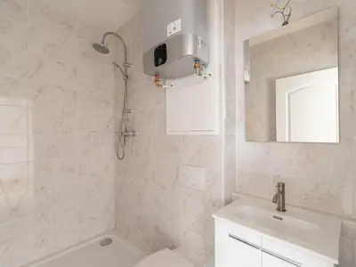 a white bathroom with a shower and a sink at Antwerpcityhome in Antwerp