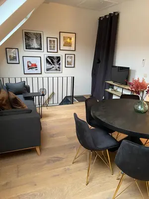 a living room with a table and a couch at Antwerpcityhome in Antwerp