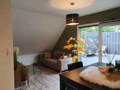 a living room with a couch and a table at De Gorzen in Oud-Turnhout