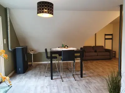 a living room with a table and a couch at De Gorzen in Oud-Turnhout