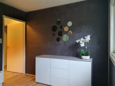 a room with a white cabinet with flowers on it at De Gorzen in Oud-Turnhout