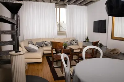 a living room with a couch and a table at Duplex dernier étage avec terasse à deux pas de la grand place in Brussels