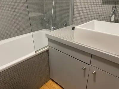a bathroom with a sink and a bath tub and a sink at Duplex dernier étage avec terasse à deux pas de la grand place in Brussels