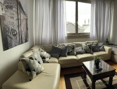 a living room with a couch and a coffee table at Duplex dernier étage avec terasse à deux pas de la grand place in Brussels