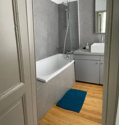 a bathroom with a bath tub and a sink at Duplex dernier étage avec terasse à deux pas de la grand place in Brussels