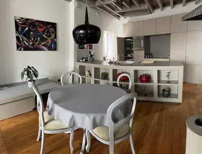 a kitchen with a table and chairs in a room at Duplex dernier étage avec terasse à deux pas de la grand place in Brussels