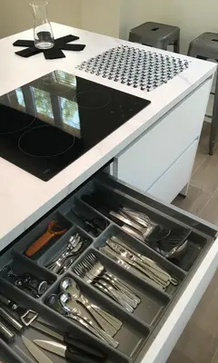 a drawer under a kitchen counter filled with utensils at Quiet and cosy apartment near the city center of Diest in Diest