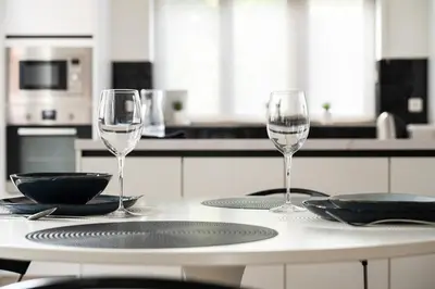 two wine glasses sitting on a table in a kitchen at Quiet and cosy apartment near the city center of Diest in Diest
