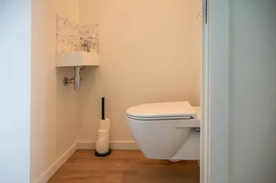 a bathroom with a white toilet in a room at Quiet and cosy apartment near the city center of Diest in Diest