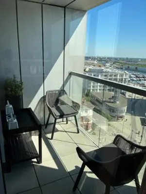 a balcony with two chairs and a table on a building at 