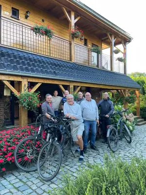a group of people standing in front of a building with bikes at Hallerbos B&B in Bluebell Forest in Halle