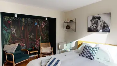 a bedroom with a bed and a painting on the wall at Suite lumineuse à Saint-Gilles in Brussels