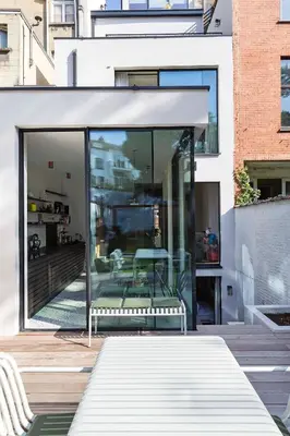 a glass house with a bench on a patio at Suite lumineuse à Saint-Gilles in Brussels