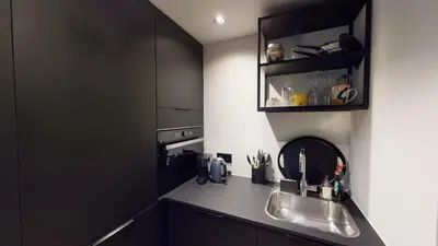 a kitchen with a sink and a counter top at Suite lumineuse à Saint-Gilles in Brussels