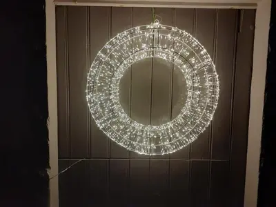 a lit up christmas wreath hanging on a door at Natuurschoon Vakantiewoning Moorsel in Moorsel
