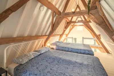 two beds in the attic of a house at The Hendrik Square Residence in Antwerp