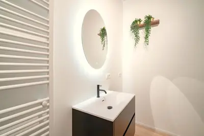 a bathroom with a sink and a mirror at The Hendrik Square Residence in Antwerp