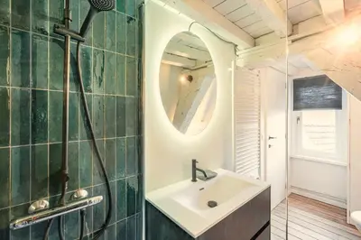 a bathroom with a sink and a mirror at The Hendrik Square Residence in Antwerp