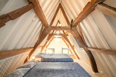 a room with two beds in a attic at The Hendrik Square Residence in Antwerp