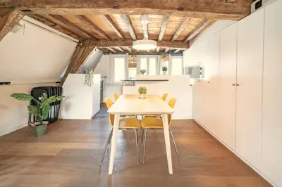 a kitchen and dining room with a table and chairs at The Charming Hendrik Square Apartments in Antwerp