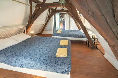 a bedroom with two beds in a attic at The Charming Hendrik Square Apartments in Antwerp