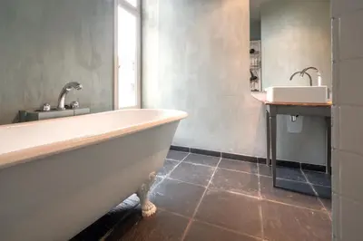 a bathroom with a tub and a sink at The Charming Hendrik Square Apartments in Antwerp
