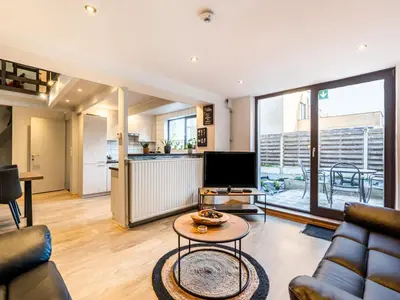 a living room with a couch and a table at Herselt Garden Shed Retreat in Herselt