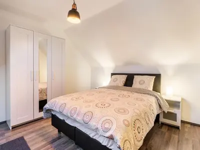 a bedroom with a bed with a pink bedspread at Herselt Garden Shed Retreat in Herselt