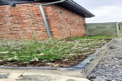 a pile of grass in front of a brick building at Herselt Garden Shed Retreat in Herselt