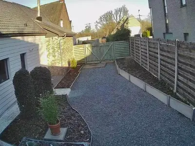 a backyard with a fence and a garden with a plant at Herselt Garden Shed Retreat in Herselt
