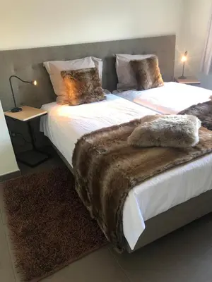 a bedroom with two beds with blankets on them at Logies Dampoort in Ghent