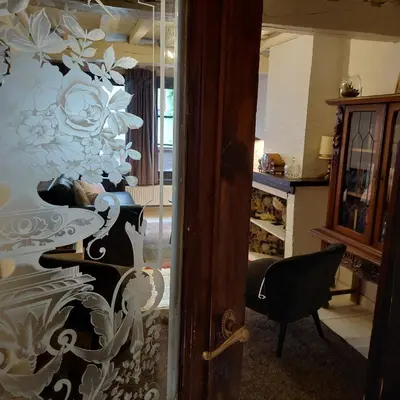 a glass door with a painting of a woman at Plezantwerpen, Zuiderzin in Antwerp