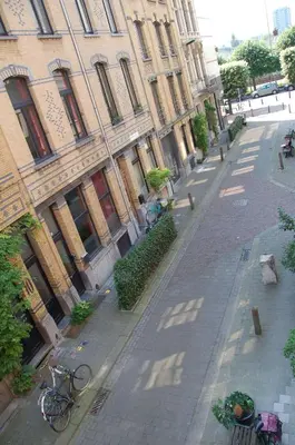 an empty street in front of a large building at Plezantwerpen, Zuiderzin in Antwerp