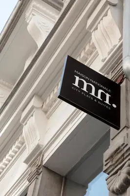 a sign on the side of a building at Maison Nationale City Flats & Suites in Antwerp
