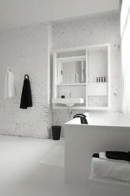 a white bathroom with a sink and a tub at Maison Nationale City Flats & Suites in Antwerp