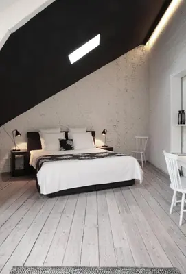 a bedroom with a large white bed and a wooden floor at Maison Nationale City Flats & Suites in Antwerp