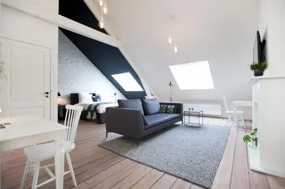 a living room with a couch and a table at Maison Nationale City Flats & Suites in Antwerp