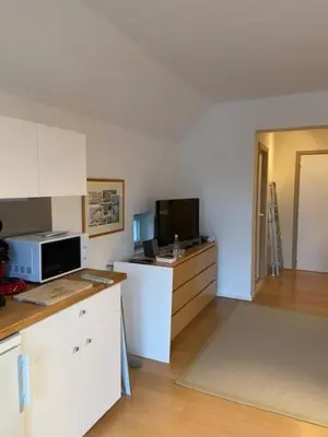 a kitchen with white cabinets and a microwave at narcisses in Sint-Genesius-Rode
