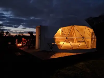 a lit up orb on a deck at night at Parkhoeve Glamping in Ham