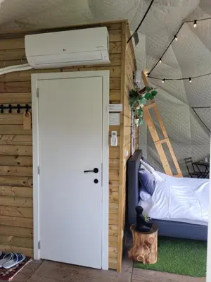 a door leading to a bed in a tent at Parkhoeve Glamping in Ham