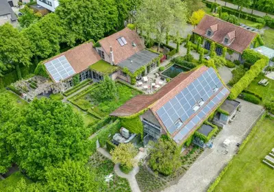 an aerial view of a house with solar panels on it at Domein Den Buiten Bed And Breakfast DnD in Sint-Niklaas