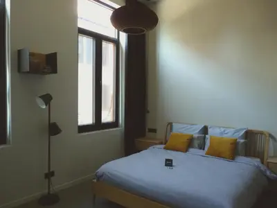 a bedroom with a bed with blue sheets and a window at Site78 in Puurs