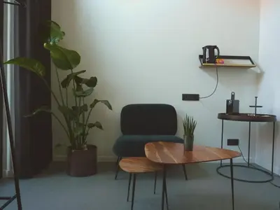 a room with a chair and a table and a plant at Site78 in Puurs